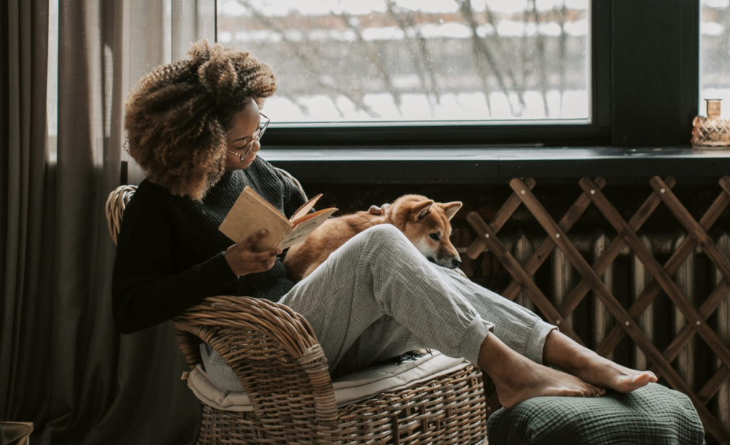 woman reading with dog